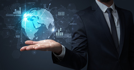 Obraz premium Businessman handing transparent global information flow concept on his hand