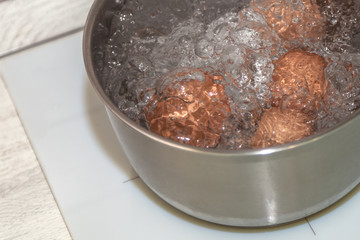 brown eggs in boiling water