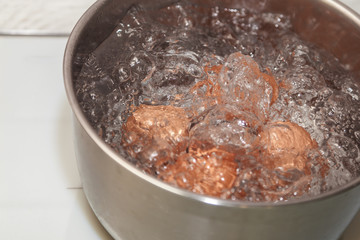 brown eggs in boiling water