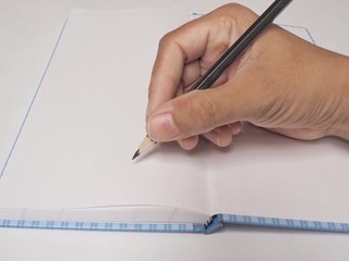 hand with pen on a sheet of paper