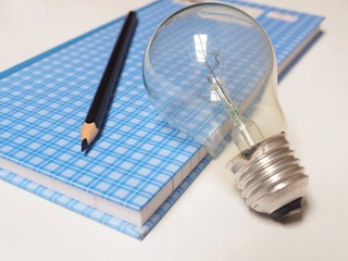 light bulb and pencil on white background