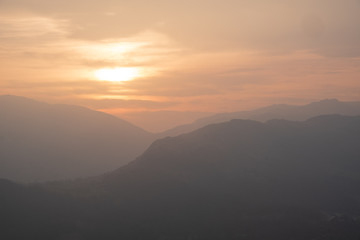 Sunset over the Wrynose Pass seen from the summit of Loughrigg Fell, Lake District, UK