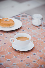 cup of coffee with bread on table in the morning with sunlight, breakfast