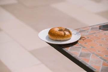 Breakfast Morning Sunny warm weather with donut on white plate on table background. Good mood Horizontal view