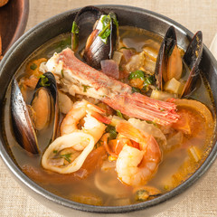 Homemade cioppino closeup - Italian-American seafood soup - fish, mussels, shrimp and squid.