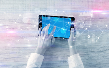 Hand using tablet with linking graphs charts  report and informational flow concept
