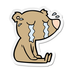 distressed sticker of a cartoon bear crying