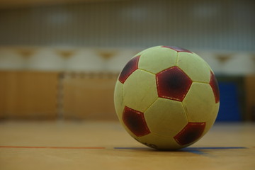 Fototapeta na wymiar soccer ball in gym with goal in background