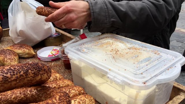 a street seller preparing Turkish bagel with sesame,Turkish street food