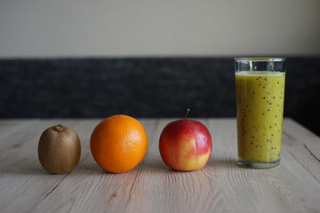 smoothie with kiwi orange and apple in glass