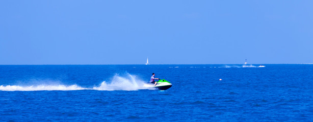 A wide background with speed water jet and white trace after him