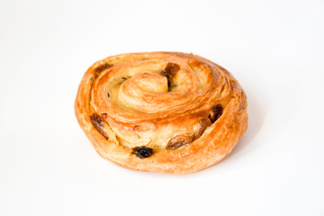 Close up fresh  cinnamon sweet rolls with dry grapes on white background, buttery rolls of flaky...