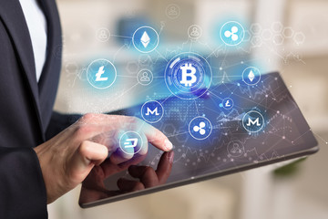 Business woman using tablet with cryptocurrency bitcoin link network concept
