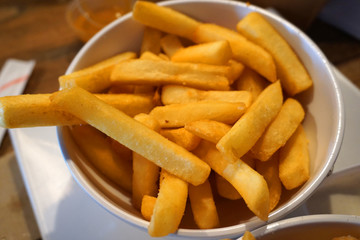 Delicious deep fried potato chip hot chip with tomato sauce french fried in white bowl snack unhealthy food junk food Western cuisine rice bran oil ketchup dipping sauce 