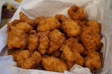 Delicious deep fried squid pepper calamari coated with crumbed bread on paper fast food seafood crispy dipping with sour cream and sweet chillies sauce snack
