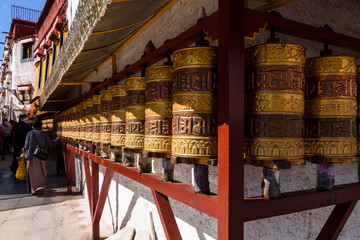 Prayer wheels in Jokhang temple. The characters (in Newari language & Tibetan) on the wheels are...