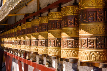 Prayer wheels in Jokhang temple. The characters (in Newari language & Tibetan) on the wheels are...