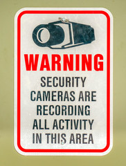 Warning sign on an area with security cameras