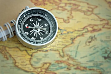 Close up of a compass on the map.