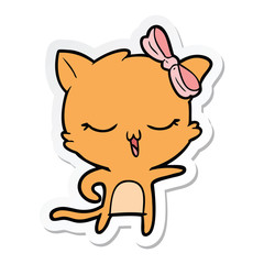 Obraz na płótnie Canvas sticker of a cartoon cat with bow on head