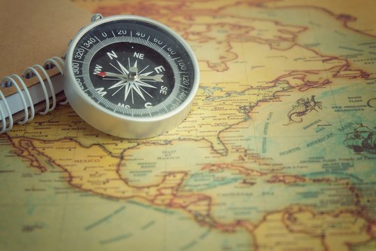 Close up of a compass on the map. © nbstockphoto