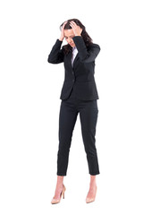 Upset stressed business woman with head in hands looking down in despair. Full body isolated on...