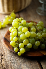 Ripe white grape on wooden desk