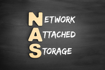 Wooden alphabets building the word NAS - Network Attached Storage acronym on blackboard