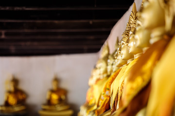 Selective focus of Aligned Buddha statues at Wat Phutthaisawan, Ayuthaya, Thailand.