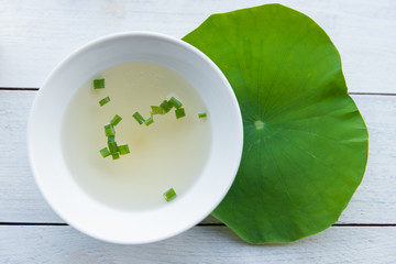 Clear soup in a white cup