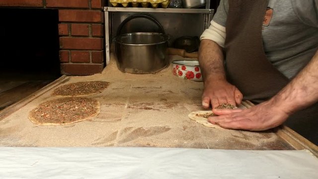 Making Turkish pizza pide, pizza with minced meat, pizza dough, male chef making turkish pide