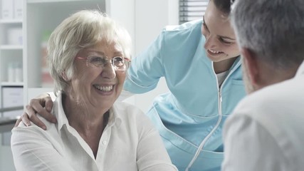 Medical staff supporting a senior patient - Powered by Adobe