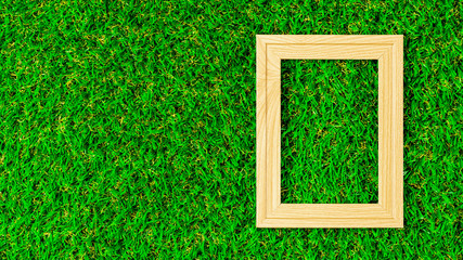 Classic wooden photo frame on green lawn.