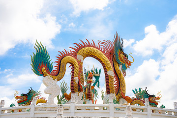 Fototapeta premium Beautiful giant or big colorful dragon statue with blue sky