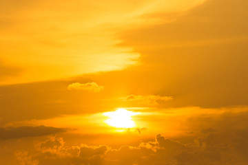 Golden yellow or orange gold sky tone and clouds at sunset or evening time.