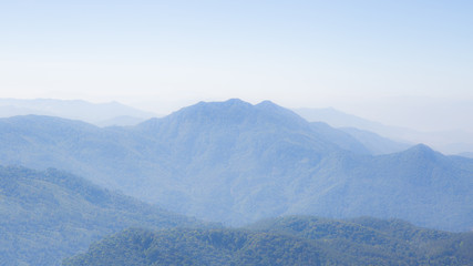 Fototapeta premium Mountain and forest cover with little white fog on the morning time.