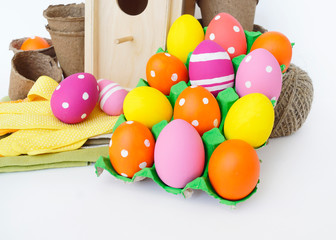Fototapeta na wymiar Decorative Easter composition. Birdhouse and Easter eggs. Flowerpots