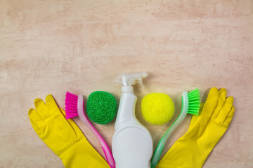 Cleaning supplies and products on wooden background, housework concept, top view with copy space