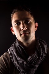 Fototapeta premium Portrait of a man standing in front of a black background.