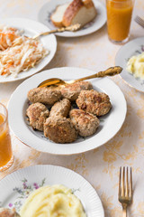 plates with meat steaks, cutlets, sauerkraut, pickled cabbage, mashed potatoes,