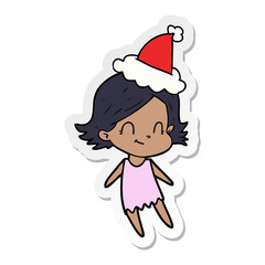 sticker cartoon of a friendly girl wearing santa hat