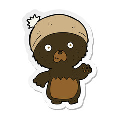 sticker of a cartoon cute teddy bear in hat