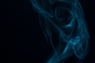 Blue smoke on black background