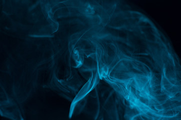 Blue smoke on black background