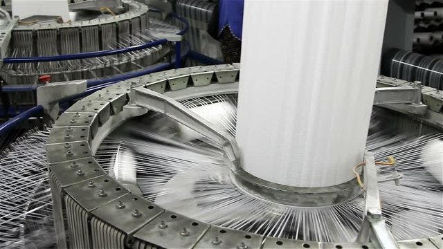 Textile industry - yarn spools on spinning machine in a factory