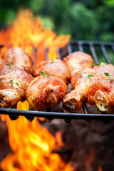 Delicious chicken leg with herbs and spices on grill