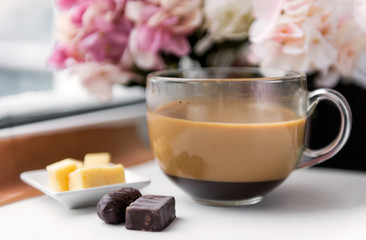 coffee mug with milk, chocolates, pieces of cheese, hydrangea flowers