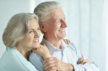 Portrait of happy senior couple on white background