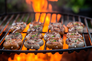 Tasty sausage on grill with herbs and spices