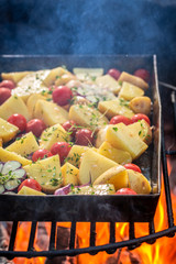 Hot baked potatoes na grill with garlic, rosemary and oil